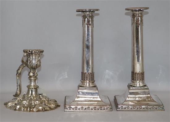 A pair of 19th century silver plated candlesticks and a rococco style chamberstick with swing handle. candlesticks height 24cm